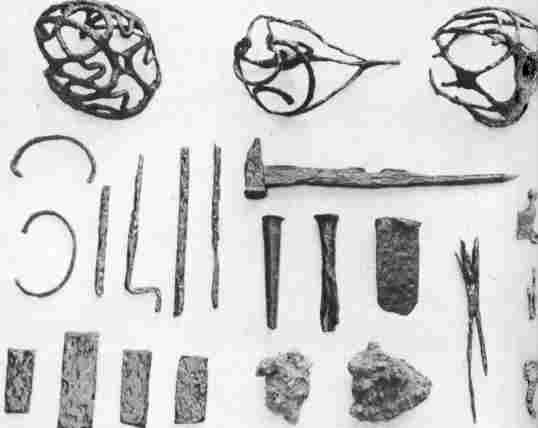 [Illustration: Objects found at a 17th-century forge site at Jamestown: blacksmith’s tools, bar iron, a few incomplete items, sword guards, and slag. It appears that the forge was in operation as early as 1625.]