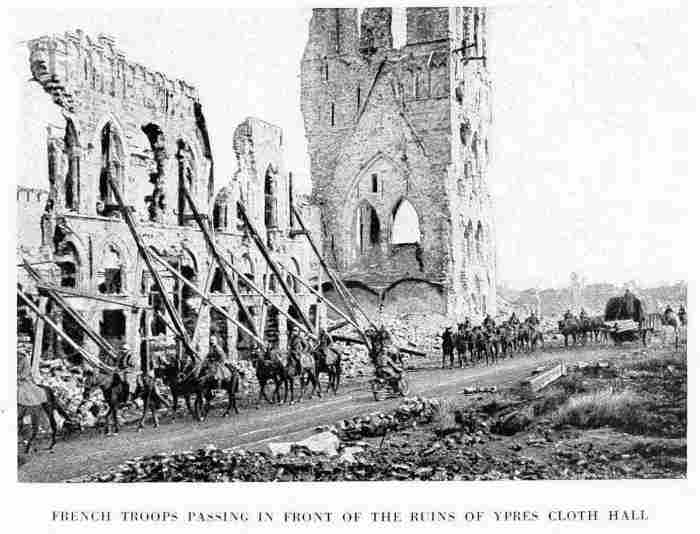 FRENCH TROOPS PASSING IN FRONT OF THE RUINS OF YPRES CLOTH HALL
