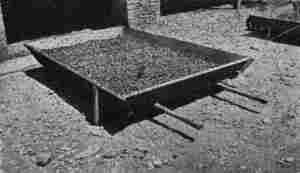 FOR DRYING SMALL QUANTITIES. A simple tray-barrow, which can be run under the house when rain comes on.