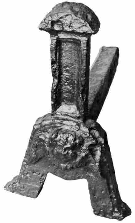 [Illustration: An early 17th-century andiron in the Jamestown collection. Note the cherub’s head near the base.]