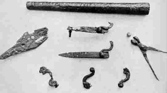 [Illustration: Early musket barrel and gun parts excavated at Jamestown.]